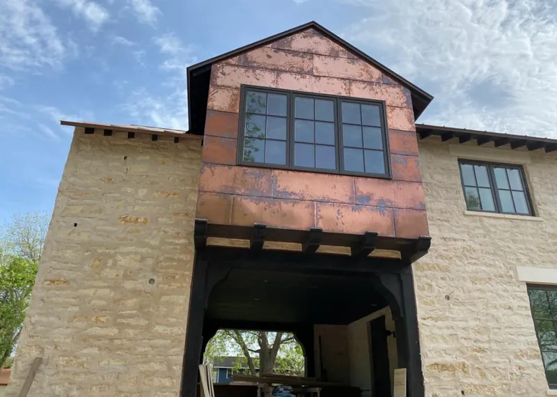 Copper metal panel facade on a stone building for Skylight Installation in Hartsville